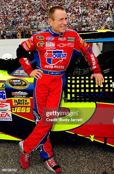 Mark Martin, driver of the CARQUEST/Kellogg's Chevrolet, stands next to his car on the grid prior to the start of the NASCAR Sprint Cup Series LENOX...