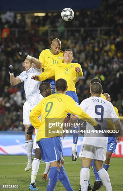 Defender Oguchi Onyewu fights for the ball with Brazilian forward Luis Fabiano and Brazilian defender Luisao during the Fifa Confederations Cup final...