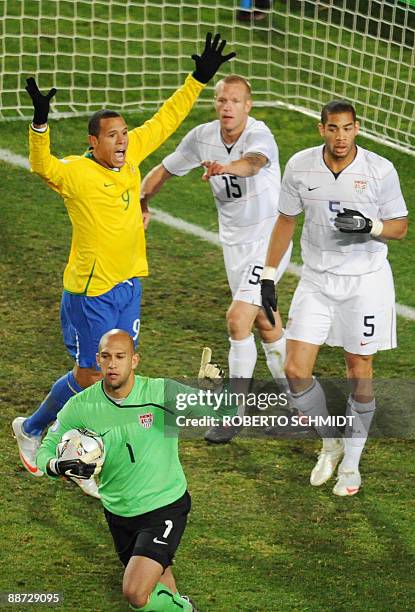 Brazilian forward Luis Fabiano complaints to the referee next to US goalkeeper Tim Howard , US defender Jay DeMerit and US defender Oguchi Onyewu...