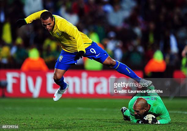 Tim Howard of USA dives to make a save at the feet of Luis Fabiano of Brazil during the FIFA Confederations Cup Final between USA and Brazil at the...