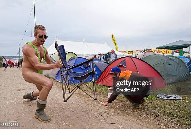 Festival-goer reatcs as another reveller shows off his "mankini" on the final evening of the annual Glastonbury festival near Glastonbury, Somerset...