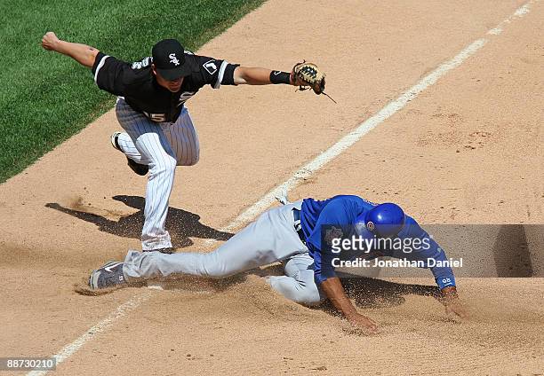 Gordon Beckham of the Chicago White Sox holds the ball up after forcing out Derrek Lee of the Chicago Cubs with the bases loaded to end the Cub half...