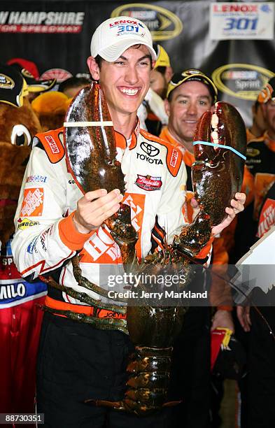 Joey Logano, driver of the Home Depot Toyota, celebrates winning the NASCAR Sprint Cup Series LENOX Industrial Tools 301 at New Hampshire Motor...