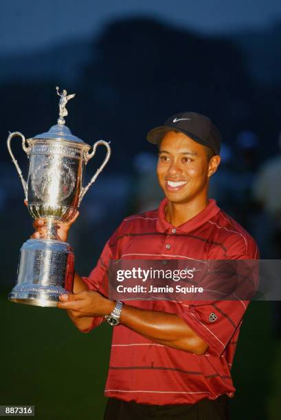 Tiger Woods poses with the trophy after winning the102nd US Open on the Black Course at Bethpage State Park in Farmingdale, New York on June 16, 2002.