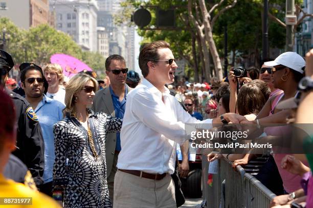 San Francisco Mayor Gavin Newsom and his wife actress Jennifer Siebel greet the crowd during the gay pride parade June 28, 2009 in San Francisco,...