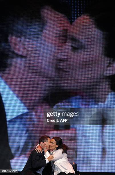 Argentina's deputy candidate for the PRO party, Gabriela Michetti , kisses Buenos Aires' Mayor Mauricio Macri, at their headquarters in Buenos Aires,...