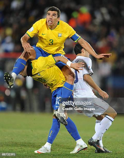 Lucio of Brazil on top of Daniel Alves compete during the 2009 Confederations Cup final match between Brazil and USA from Ellis Park on June 28, 2009...