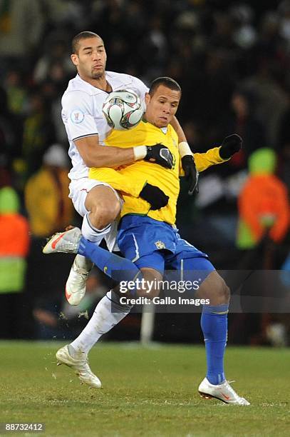 Oguchi Onyewu and Luis Fabiano compete during the 2009 Confederations Cup final match between Brazil and USA from Ellis Park on June 28, 2009 in...