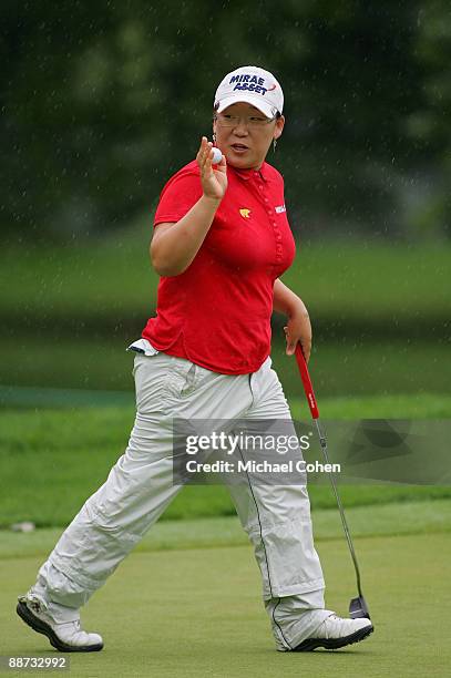Jiyai Shin of South Korea acknowledges the gallery after making birdie on the 17th green during the final round of the Wegmans LPGA at Locust Hill...