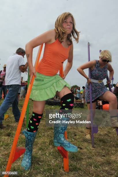 Fans try stilt walking classes during the Glastonbury Festival at the Worthy Farm on June 28, 2009 in Glastonbury, England.