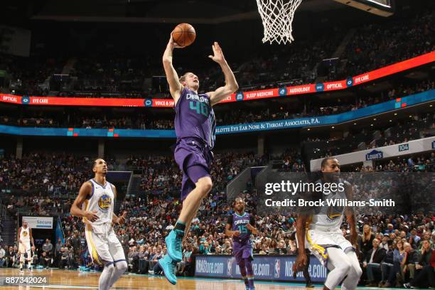 Cody Zeller of the Charlotte Hornets drives to the basket against the Golden State Warriors on December 6, 2017 at Spectrum Center in Charlotte,...