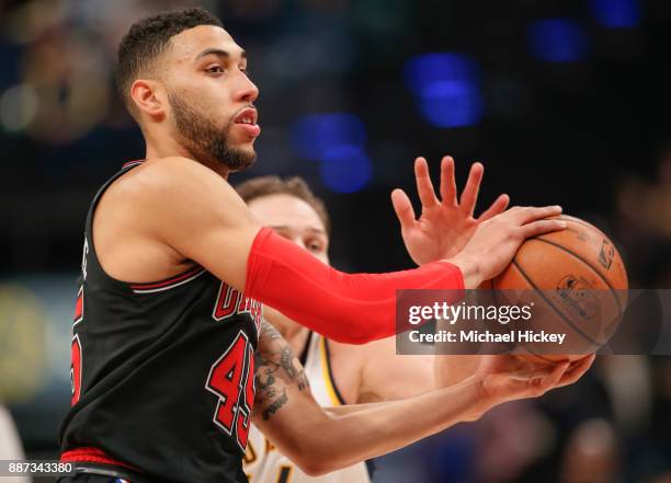 Denzel Valentine of the Chicago Bulls passes the ball off during the game against the Indiana Pacers at Bankers Life Fieldhouse on December 6, 2017...