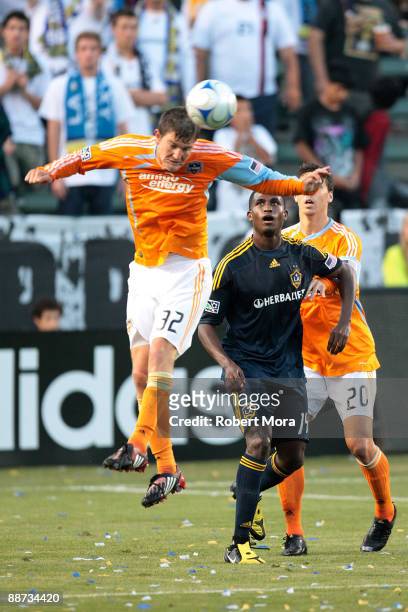 Bobby Boswell of the Houston Dynamo heads away a ball against the defense of the Los Angeles Galaxy during their MLS game at The Home Depot Center on...