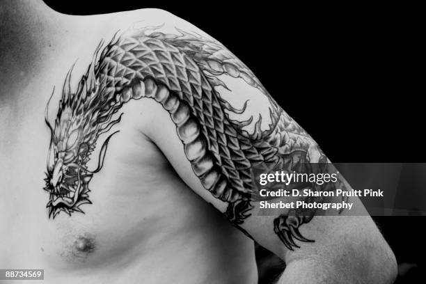 man's arm half sleeve chinese black dragon tattoo - lättklädd bildbanksfoton och bilder