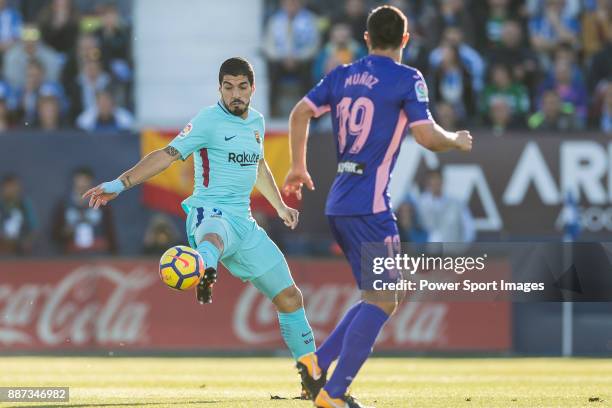 Luis Alberto Suarez Diaz of FC Barcelona fights for the ball with Ruben Salvador Perez del Marmol of CD Leganes and Ezequiel Matias Munoz of CD...