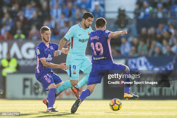 Luis Alberto Suarez Diaz of FC Barcelona fights for the ball with Ruben Salvador Perez del Marmol of CD Leganes and Ezequiel Matias Munoz of CD...