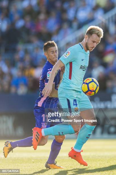 Ivan Rakitic of FC Barcelona fights for the ball with Alexander Szymanowski of CD Leganes during the La Liga 2017-18 match between CD Leganes vs FC...