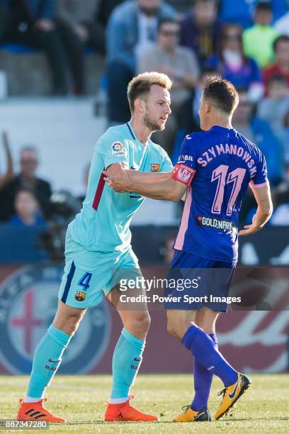 Ivan Rakitic of FC Barcelona confronts with Alexander Szymanowski of CD Leganes during the La Liga 2017-18 match between CD Leganes vs FC Barcelona...