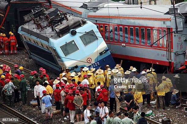 Chinese rescuers search for victims following a train collision at the railway station in Chenzhou city, in central China's Hunan province on June...