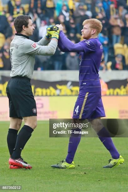 Goalkeeper Martin Maennel of Aue hugs Fabian Kalig of Aue during the Second Bundesliga match between SG Dynamo Dresden and FC Erzgebirge Aue at...