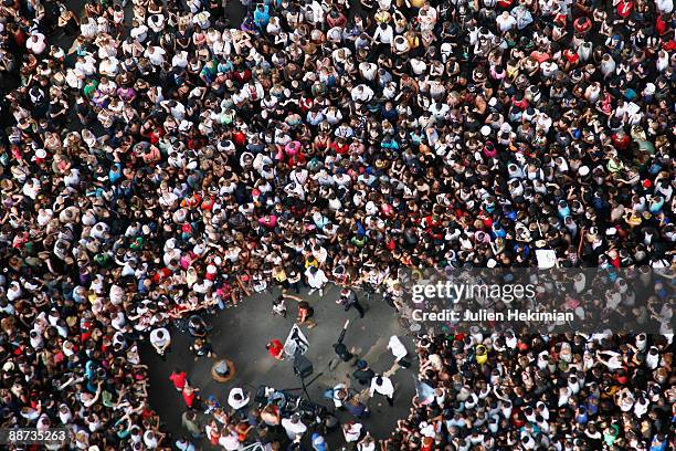 Thousand of Michael Jackson fans gather at the Eiffel Tower to watch a Michael Jackson look alike dancing the moonwalk on June 28, 2009 in Paris,...