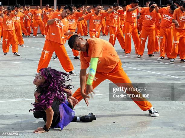 Inmates perform a dance routine in the syle of late pop icon Michael Jackson's hit song 'Thriller' at the provincial jail in Cebu city on June 27,...