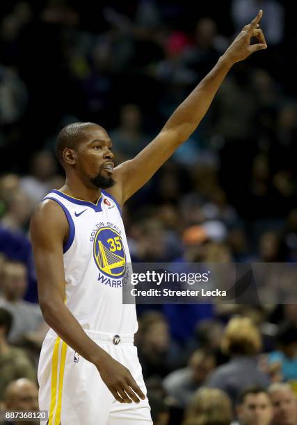 Kevin Durant of the Golden State Warriors walks onto the court against the Charlotte Hornets before their game at Spectrum Center on December 6, 2017...