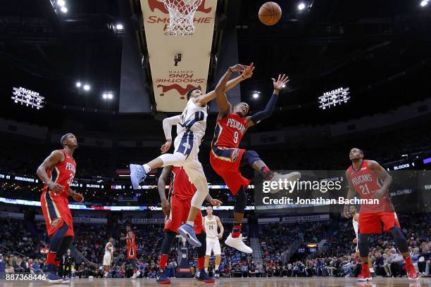 Rajon Rondo of the New Orleans Pelicans and Jamal Murray of the Denver Nuggets go for a rebound during the second half of a game at the Smoothie King...