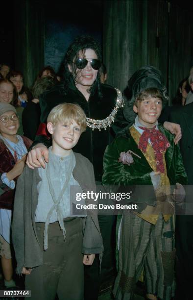 American singer Michael Jackson poses with cast members at a performance of the musical 'Oliver!' at the Palladium Theatre, London, 4th October 1996.