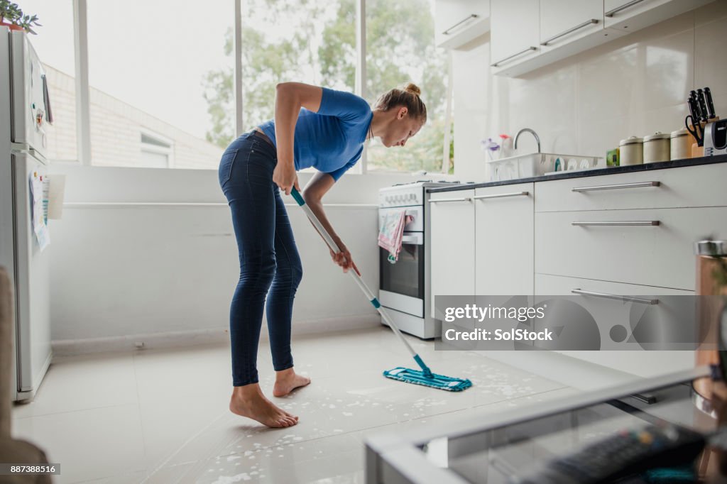 Young Female Cleaning Floor