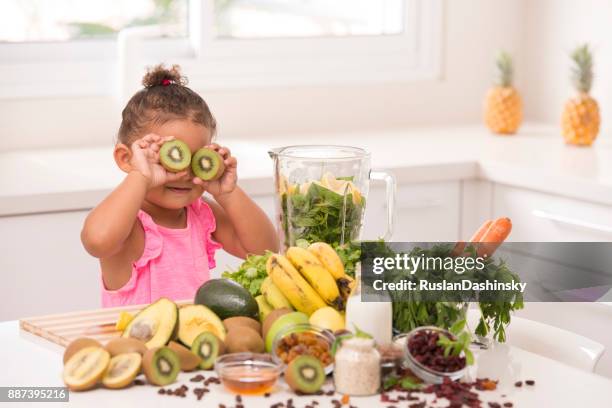 making juices is fun. 2-3 years old assistant in the kitchen. - mint plant family stock pictures, royalty-free photos & images