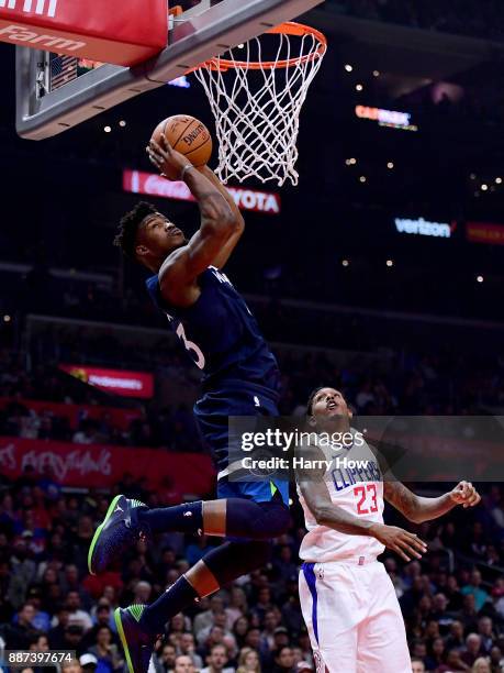 Jimmy Butler of the Minnesota Timberwolves scores on an alley in front of Lou Williams of the LA Clippers during the first half at Staples Center on...