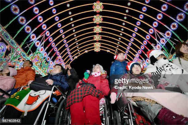 People with disabilities visit the venue of the Kobe Luminarie light festival in Kobe on Dec. 6, 2017. The organizers invited them two days before...