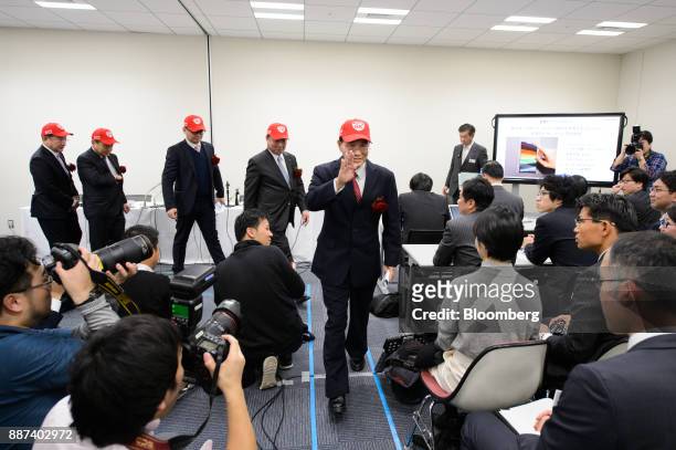 Tai Jeng Wu, president and chief executive officer of Sharp Corp., center, and other executives leave a news conference in Tokyo, Japan, on Thursday,...