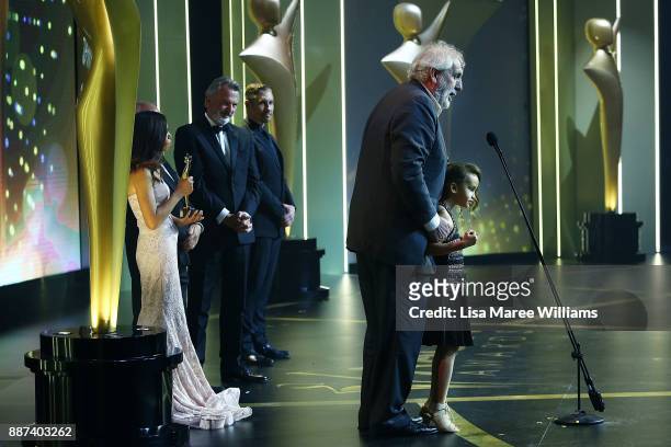 Phillip Noyce accepts the Longford Lyell Award with his daughter Ayanda Noyce during the 7th AACTA Awards Presented by Foxtel at The Star on December...