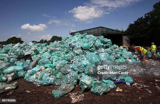 Volunteer worker sorts rubbish for recycling at the Glastonbury Festival recycling centre on June 29, 2009 in Glastonbury, England. Every year the...