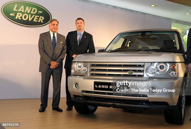 Ratan Tata and Phil Popham pose with a Land Rover at the launch of Jaguar, Land Rover, in Mumbai on June 28, 2009.