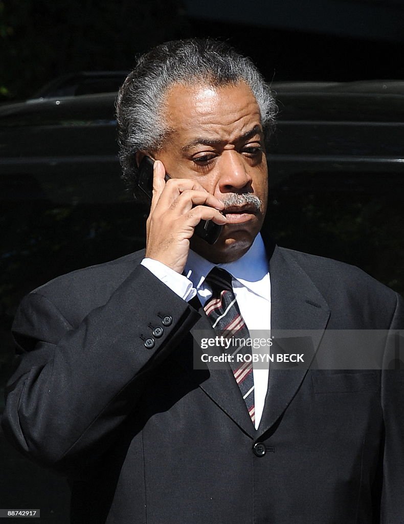 The Rev. Al Sharpton speaks on his phone as he arrives outside the ...