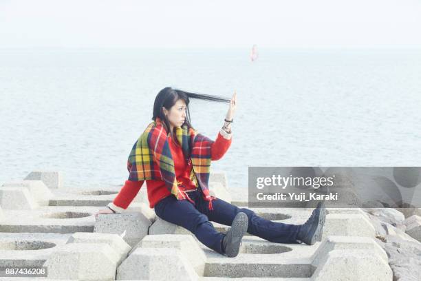 sitting on the tetrapod doing nothing - erosion control stock pictures, royalty-free photos & images