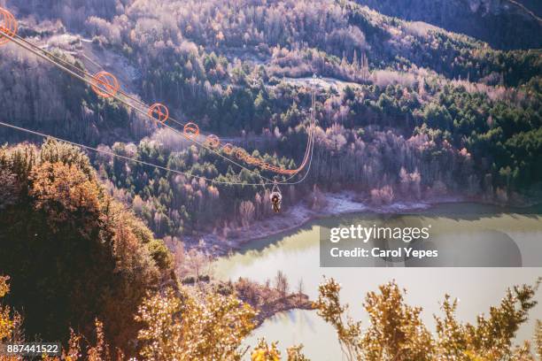 rear view view of man enjoying a beautiful  view from zipline in huesca,spain - jaca stock pictures, royalty-free photos & images