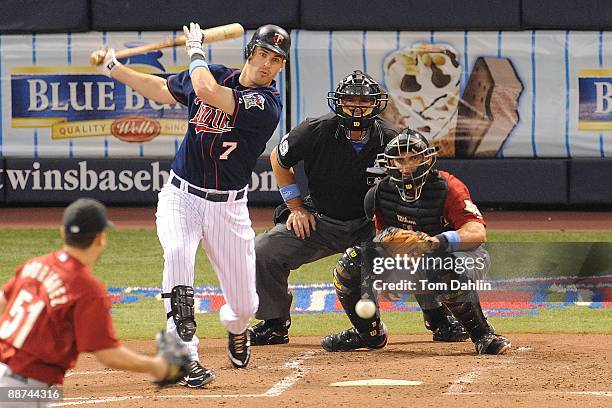 Joe Mauer of the Minnesota Twins follows through on a hit during an MLB game against the Houston Astros at the Hubert H. Humphrey Metrodome, June 21,...