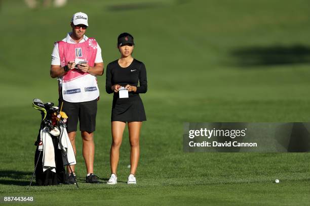 Muni He of China waits to play her third shot on the par 5, 10th hole with her caddie Stephen Deane of Northern Ireland during the second round of...