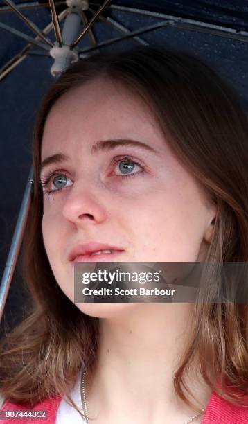 Woman cries as she gathers with a crowd of people to watch a large television screen at Federation Square as it is announced that same-sex marriage...