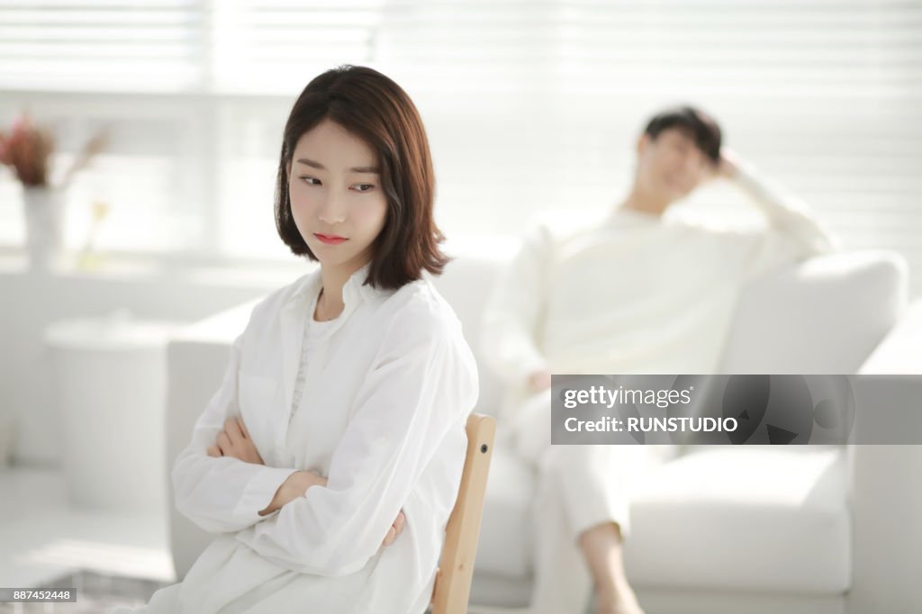 Woman with angry expression, man in background