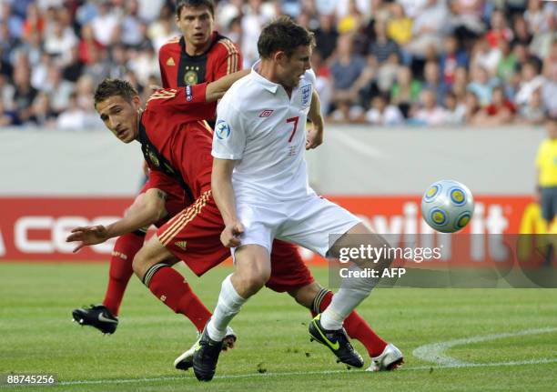 Germany's Sebastian Boenisch and England's James Milner battle for the ball in front of Germany's Fabian Johnson in the U21 European Championship...