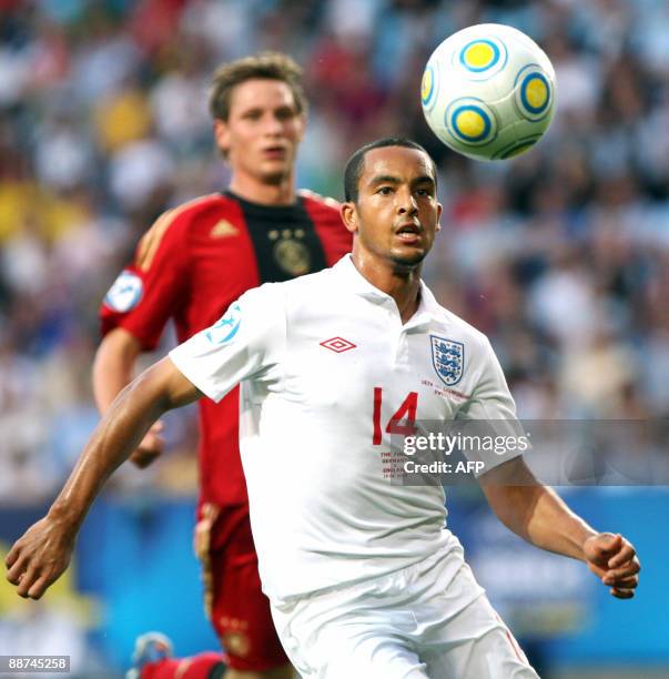 England�s Theo Walcott keeps his eye on the ball on the ball in front of Germany's Benedikt Höwedes in the U21 European Championship final soccer...