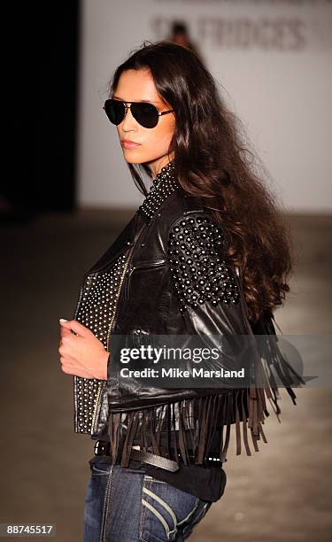 Model walks the runway at the Autumn Winter collection of 'William Rast' at Selfridges on June 29, 2009 in London, England.