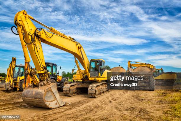 road construction machinery on the construction of highway - pá escavadora imagens e fotografias de stock