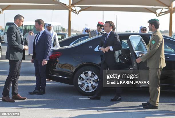 French President Emmanuel Macron disembarks a vehicle upon his arrival at the al-Udeid Air Base in the Qatari capital Doha on December 7, 2017.