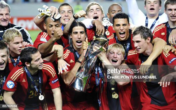 Germany players celebrate with the trophy their victory over England in the Under 21 European Championship final at the Malmo New Stadium on June 29,...